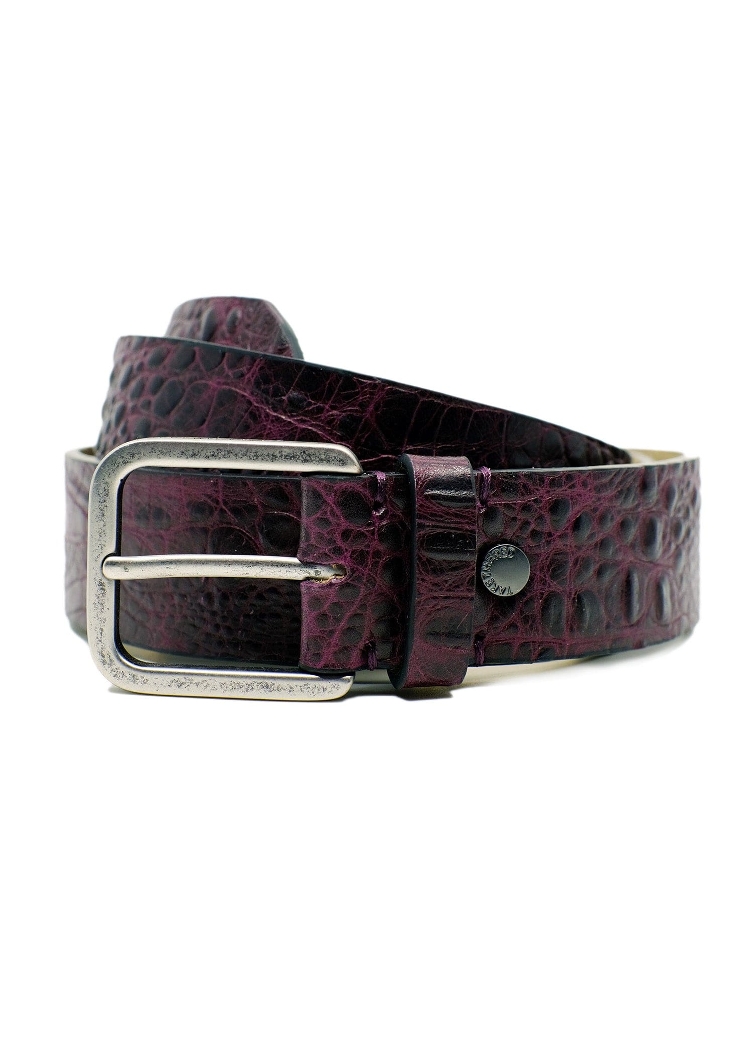 Coiled Dirty Aubergine alligator embossed leather belt with a weathered silver-tone buckle and black rivet detail.