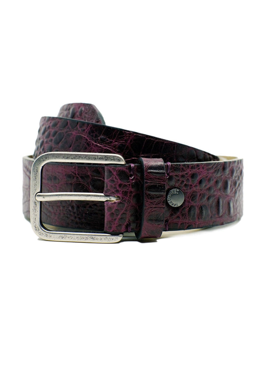Coiled Dirty Aubergine alligator embossed leather belt with a weathered silver-tone buckle and black rivet detail.