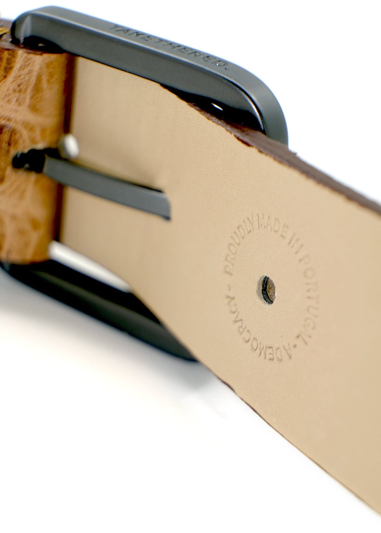 Interior view of the tan Desert Sand belt showing the matte black buckle and a "PROUDLY MADE IN PORTUGAL" stamp.