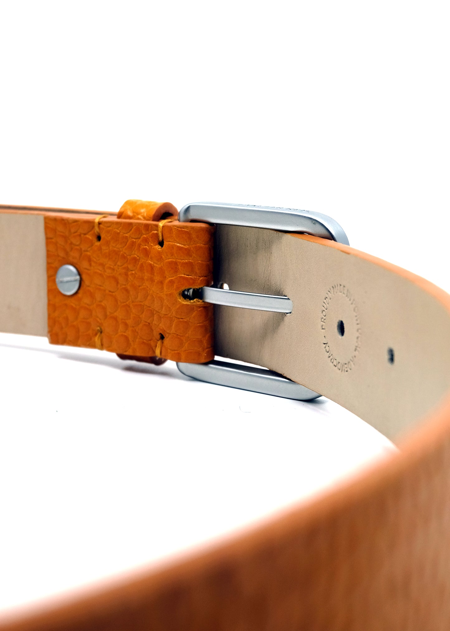 Interior view of a Submarine Yellow belt showing a silver buckle and a "PROUDLY MADE IN PORTUGAL" embossed stamp.