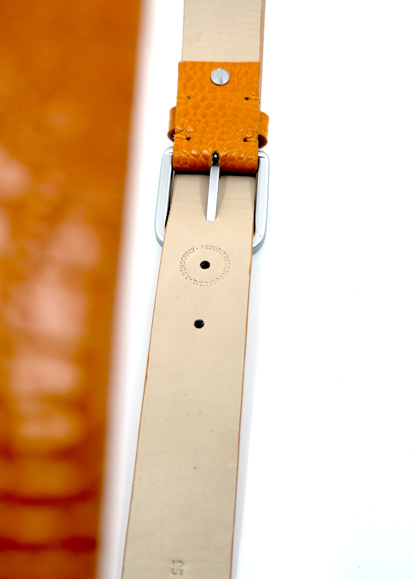 Over view of the Submarine Yellow belt showing the silver metal buckle and a "PROUDLY MADE IN PORTUGAL" stamp.