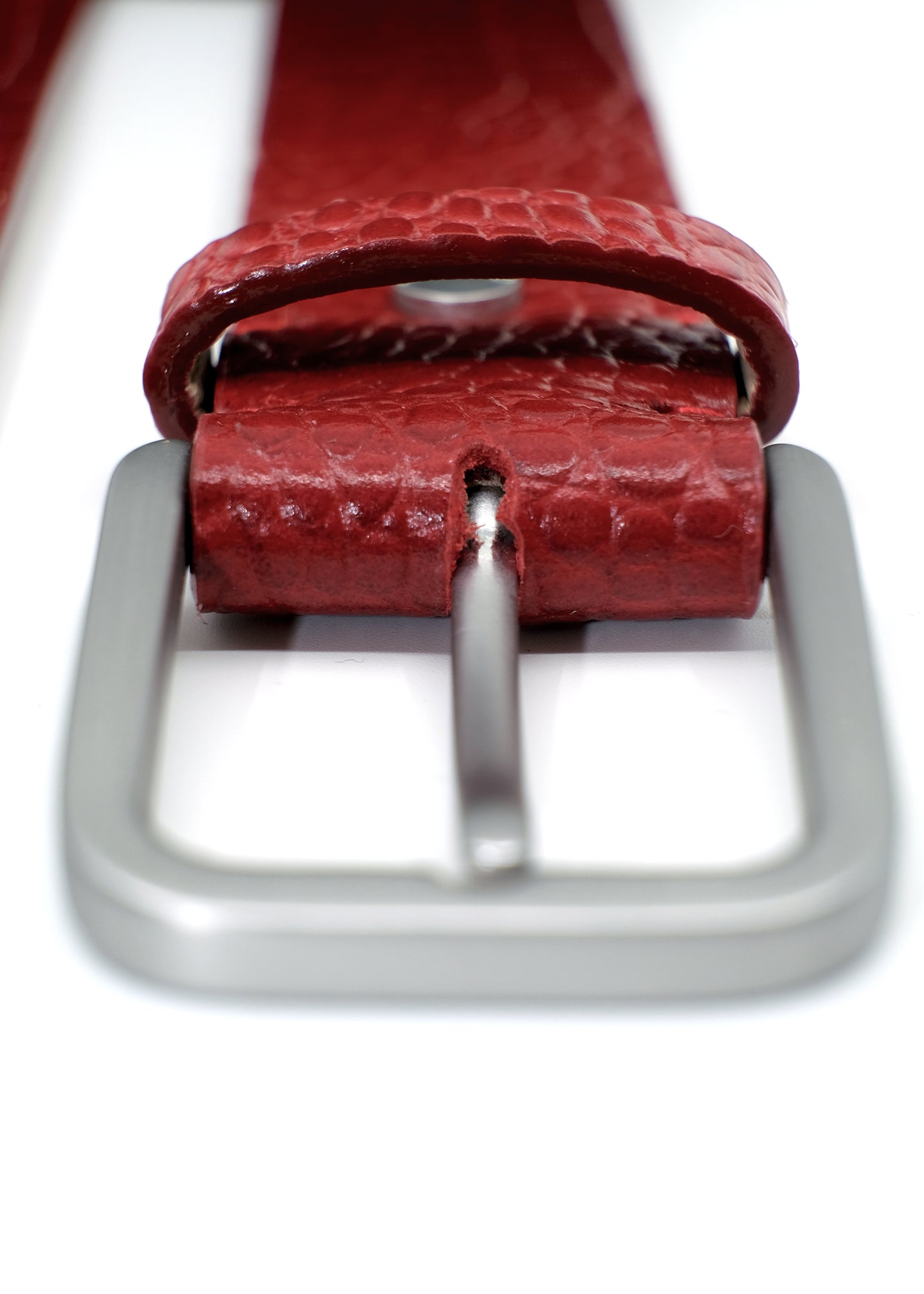 Close-up view of the blood red alligator-embossed Mississippi Belt with a close-up of the silver metal buckle.