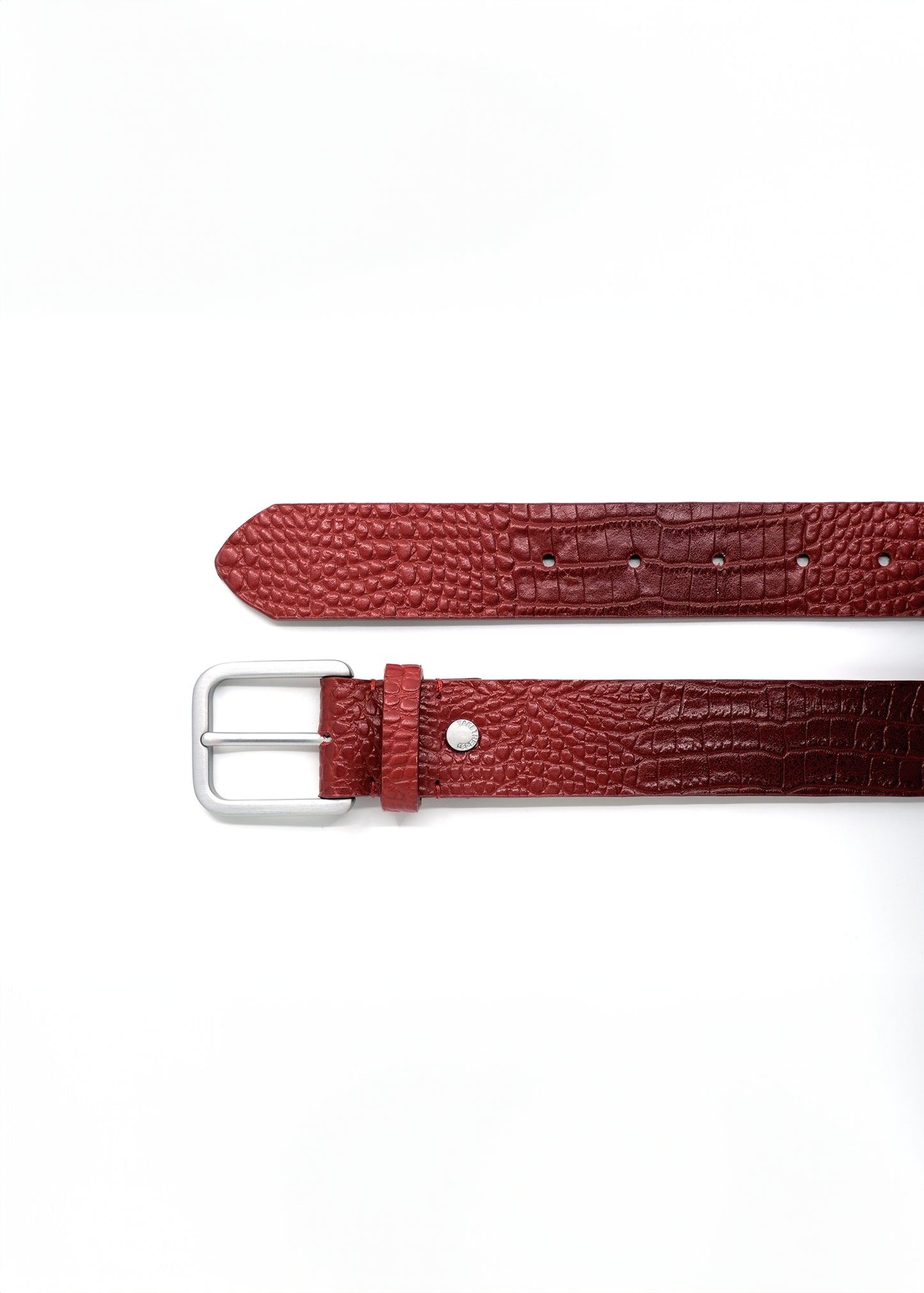 Top-down view of the blood red alligator-embossed Mississippi Belt with a silver metal buckle and detailed texture.