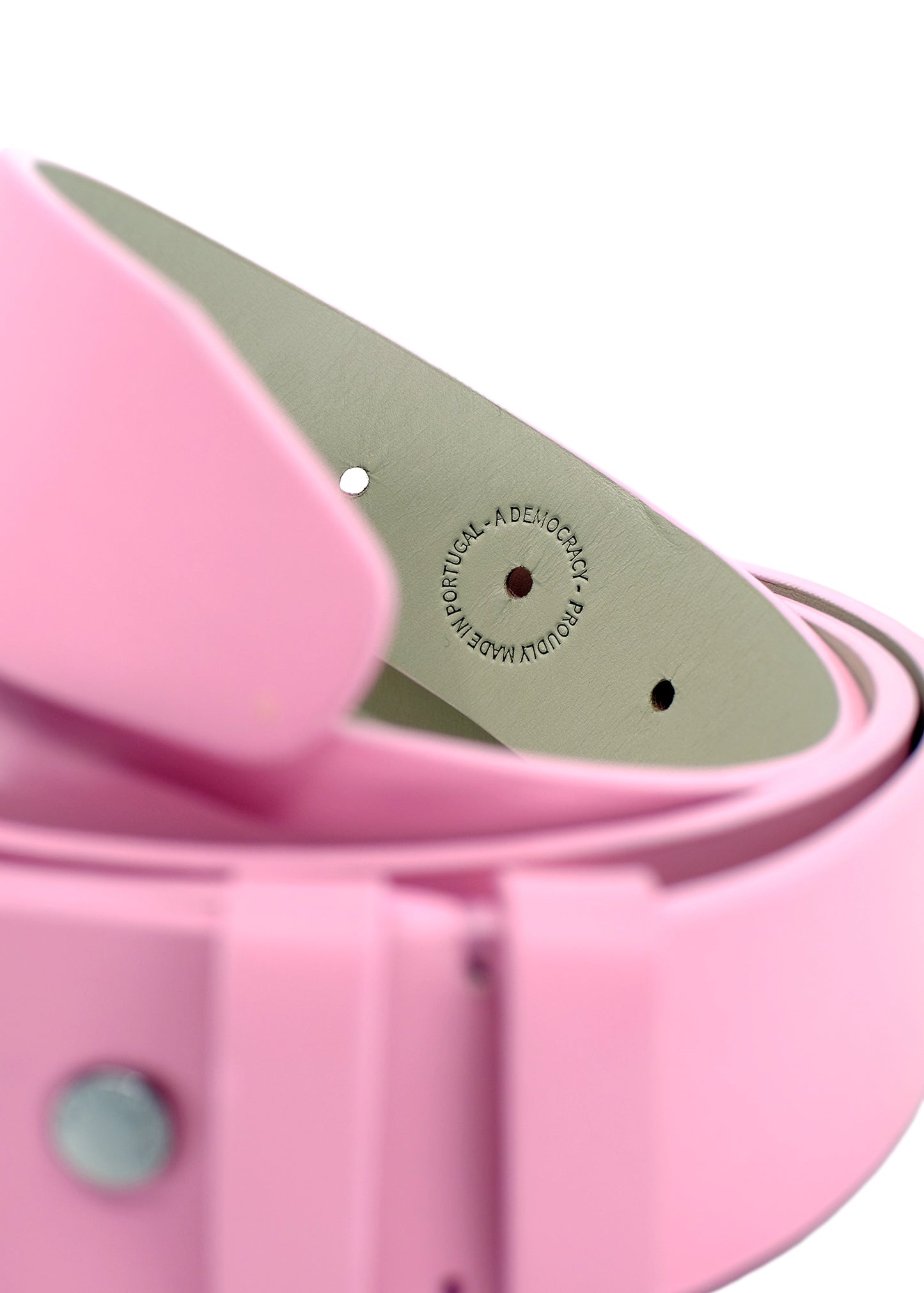 Close-up of Barbie Pink belt interior with "Proudly Made in Portugal - A Democracy" stamp on grey leather lining.