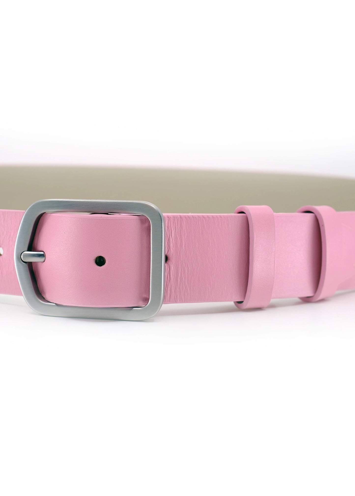 Close-up of Barbie Pink smooth leather belt with a weathered silver buckle and double leather loops.