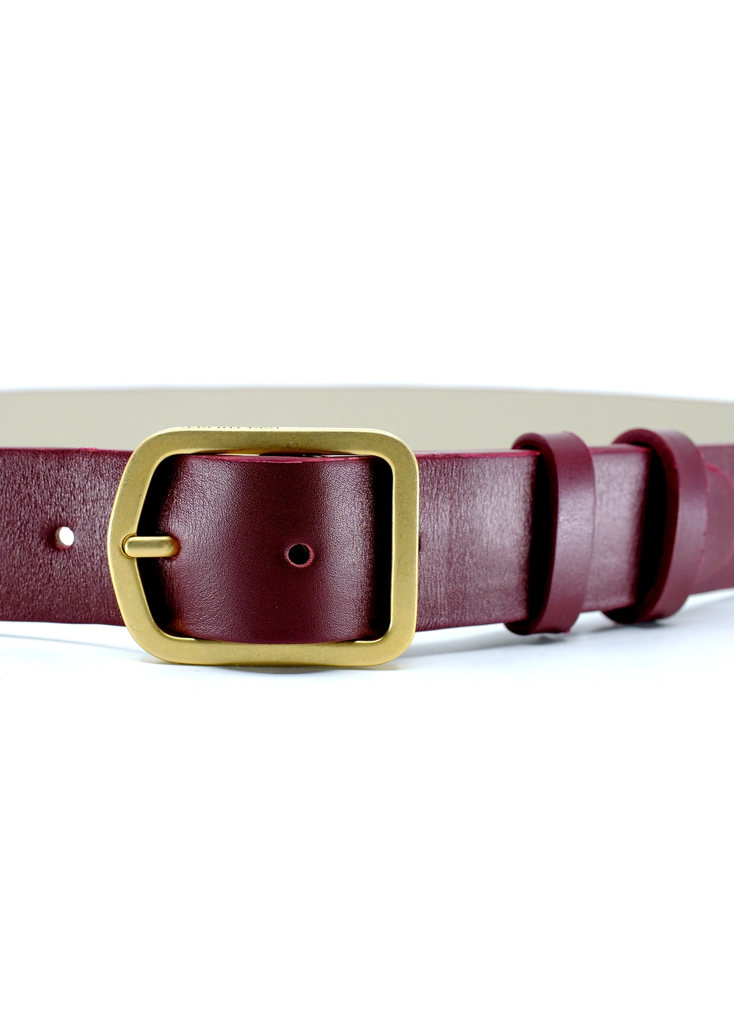 Close-up of Classic Red Mist burgundy leather belt with a matte gold buckle and double leather loops.