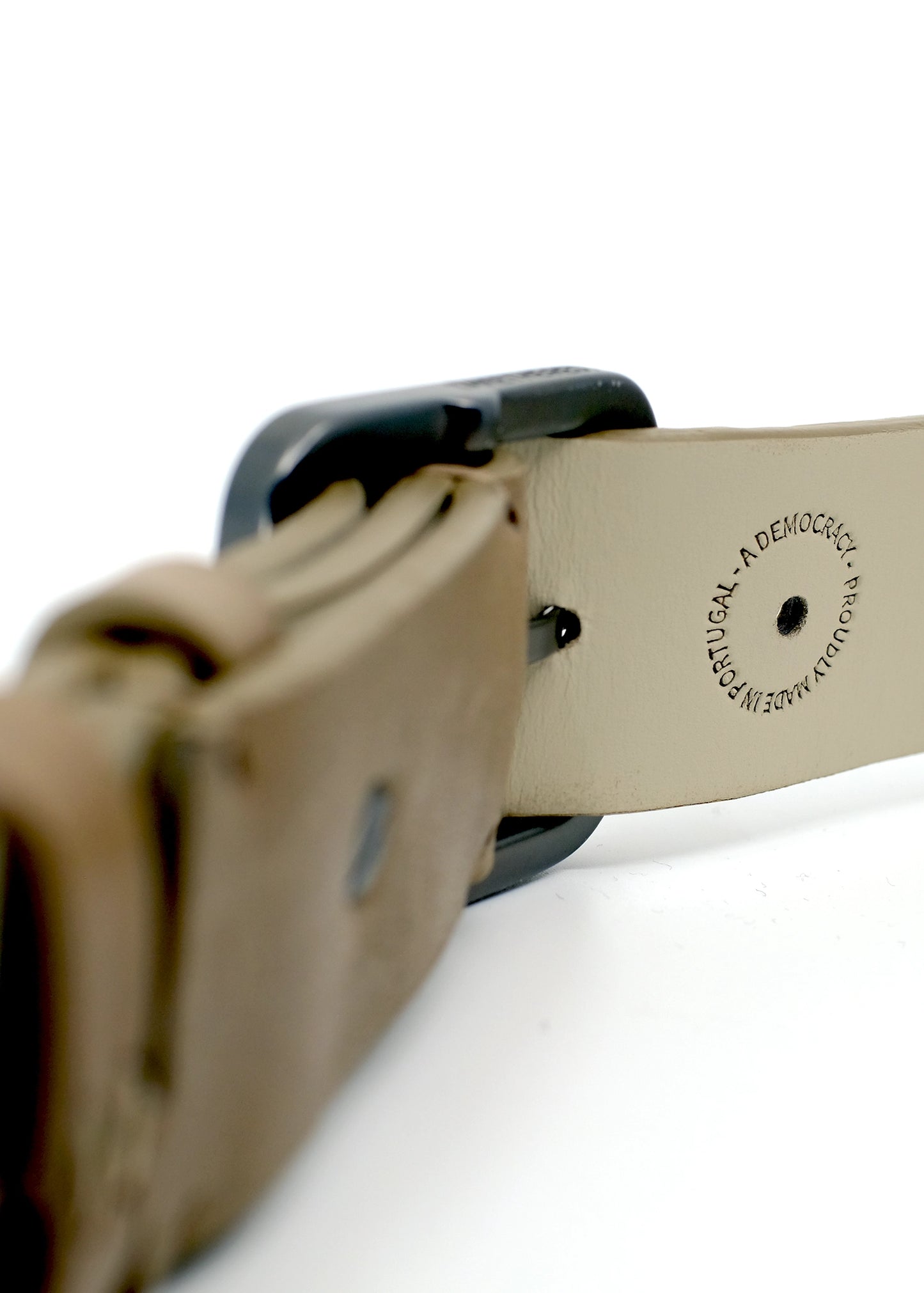 Interior view of Truffle Brown belt with "Proudly Made in Portugal" stamp near the gunmetal buckle.