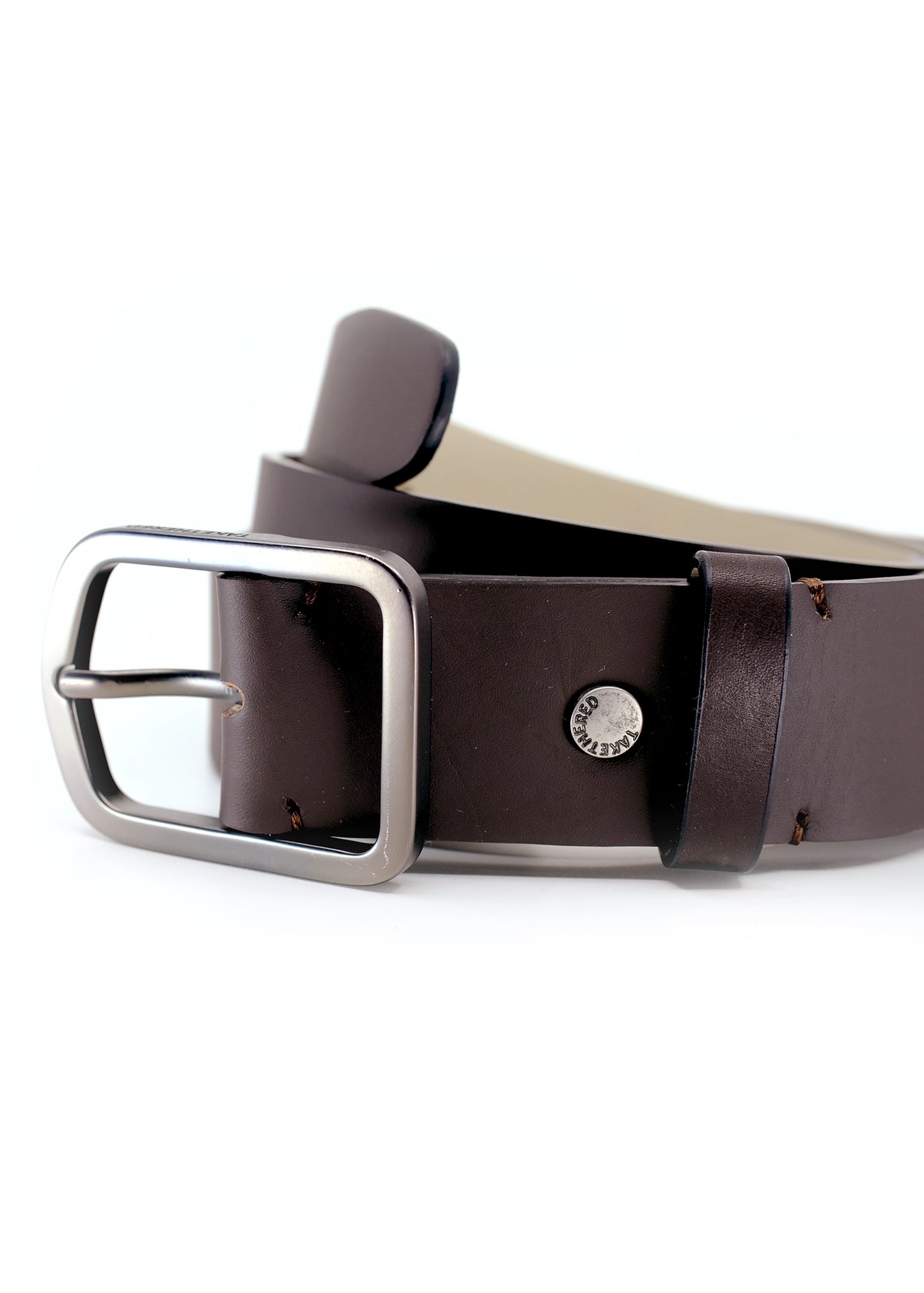 Close-up of Classic Espresso smooth dark brown leather belt with a gunmetal buckle and silver "TAKETHERED." rivet.