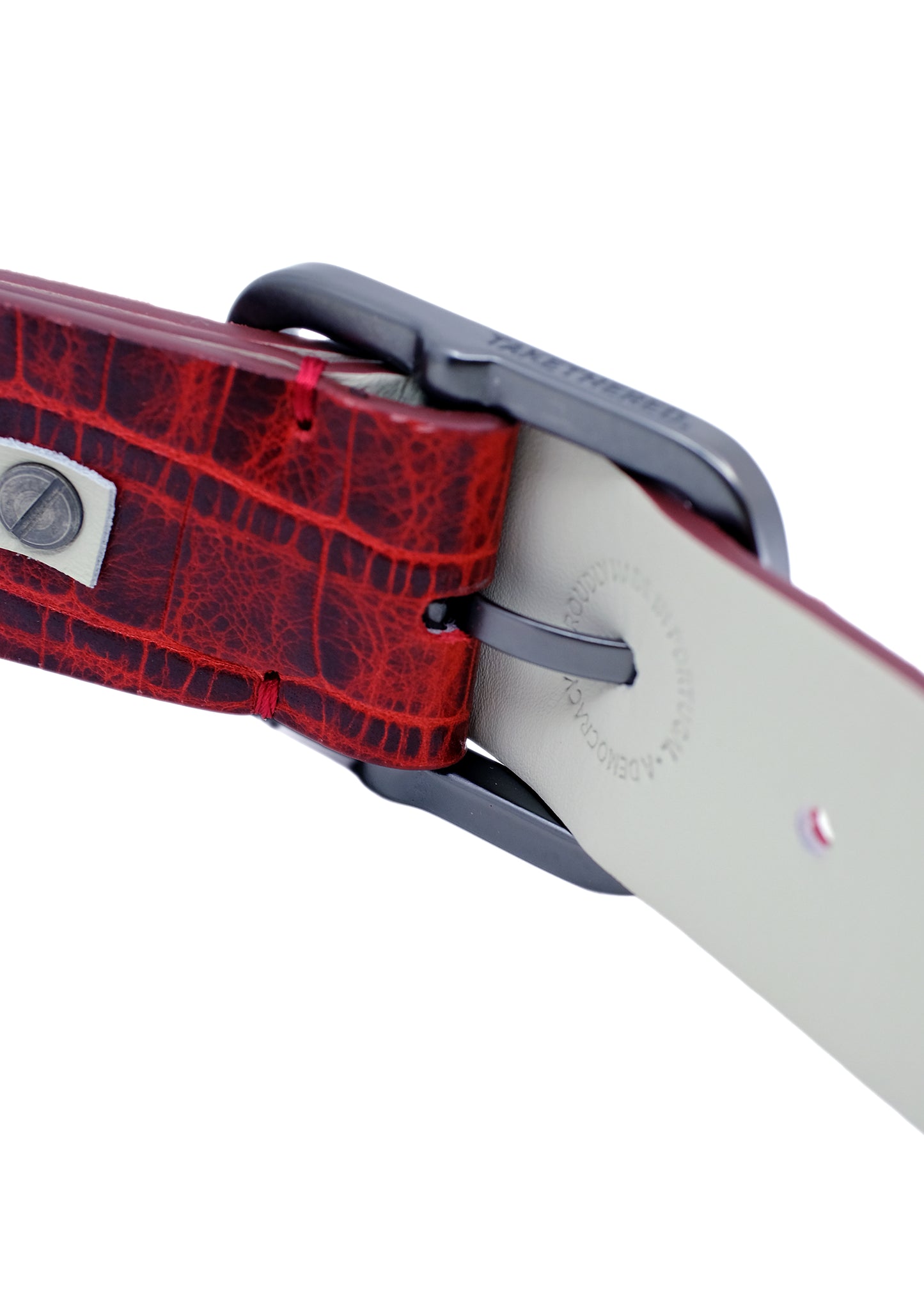 Close-up of the Pink Grape belt's interior lining and black buckle, featuring the "Proudly Made in Portugal" stamp and high-quality red stitching.
