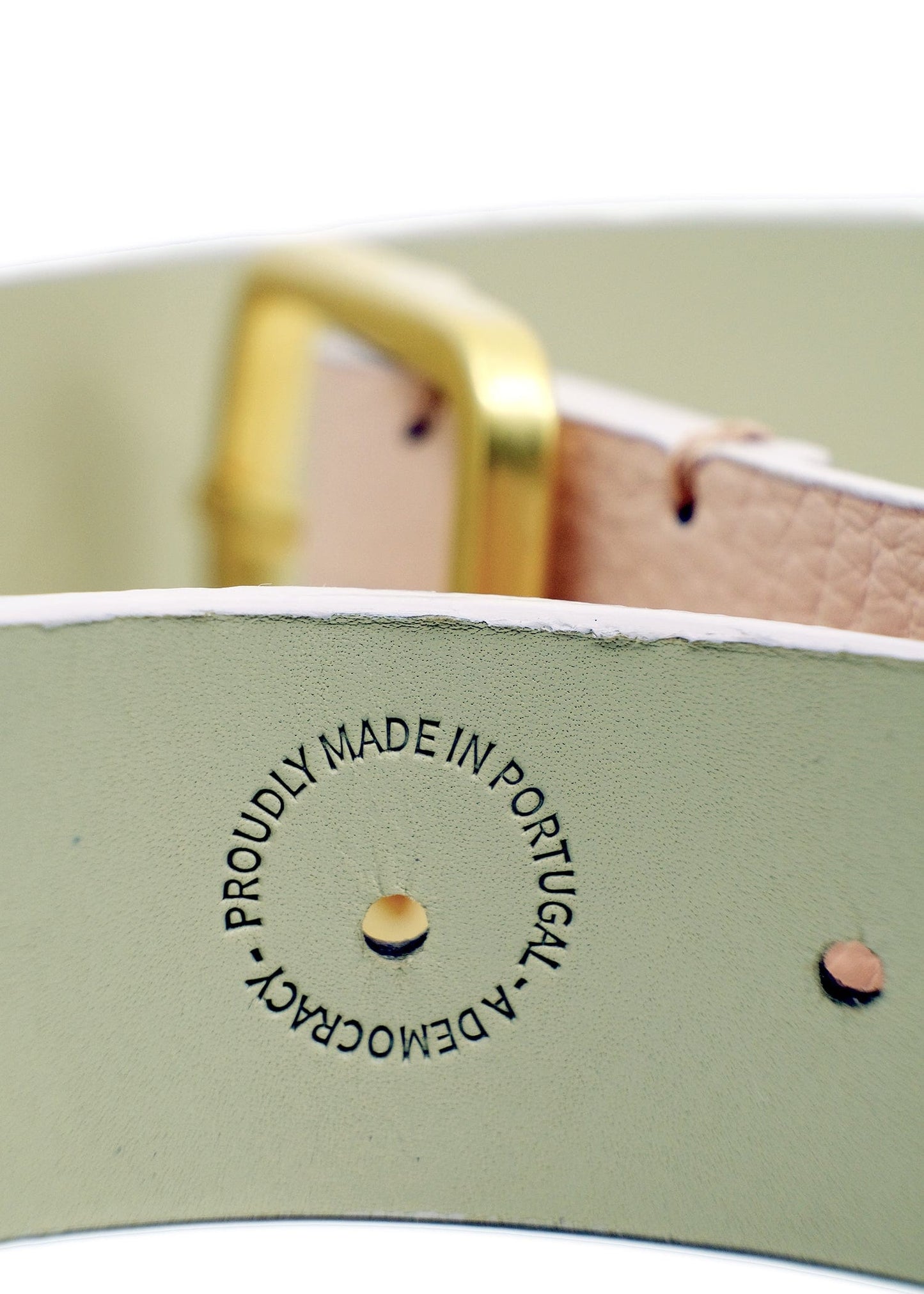 Close-up of the Nude Pink belt interior featuring a "PROUDLY MADE IN PORTUGAL - A DEMOCRACY" embossed stamp.