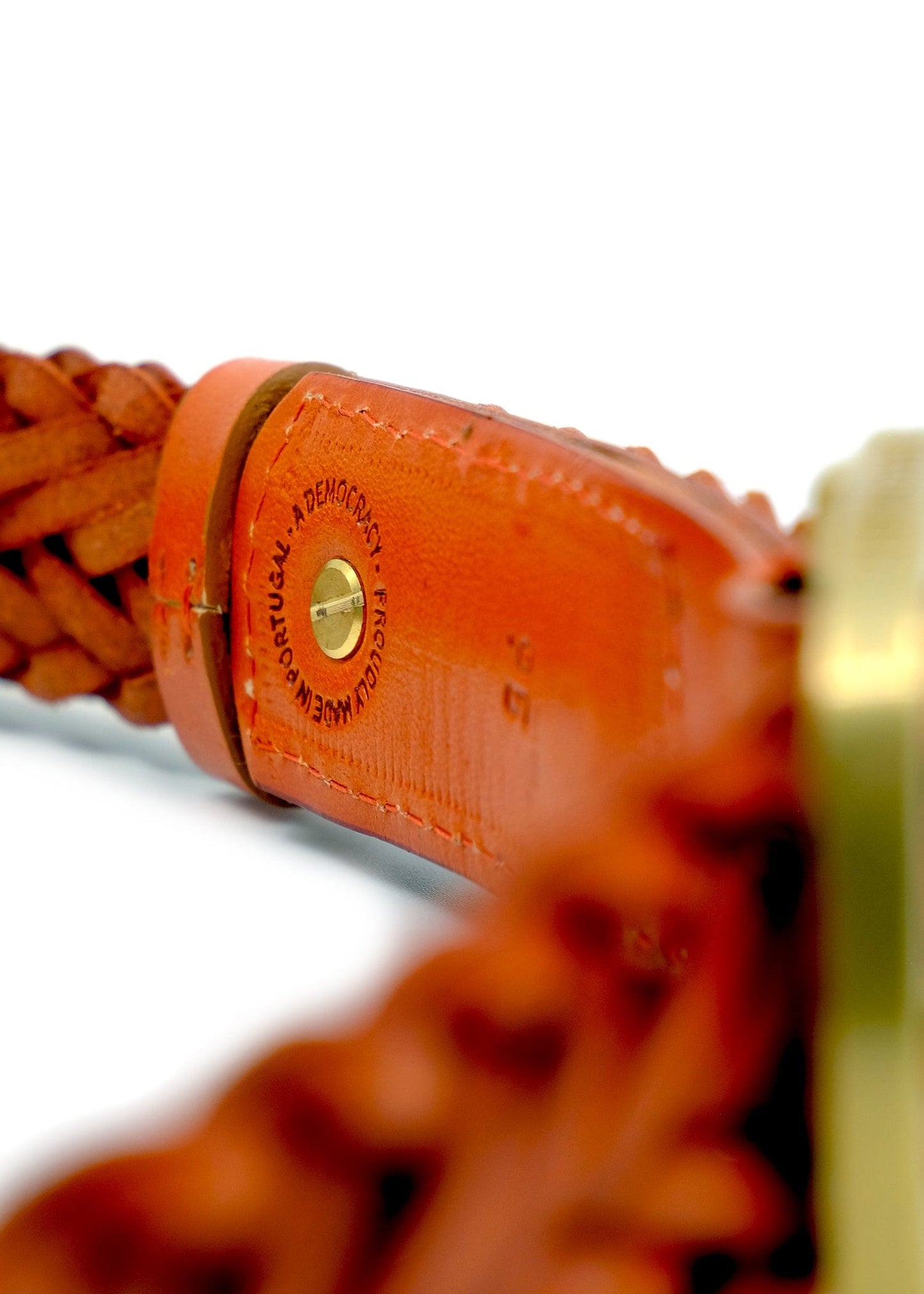 Interior view of Tatooine Sunset orange belt showing the "Proudly Made in Portugal" stamp and gold rivet.