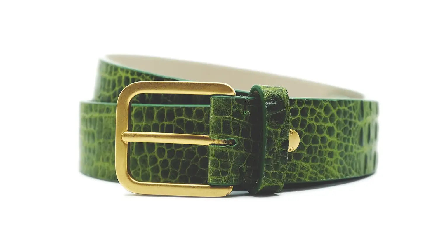 Macro close-up of a croco embossed Mississippi leather belt in atomic green with a gold buckle.
