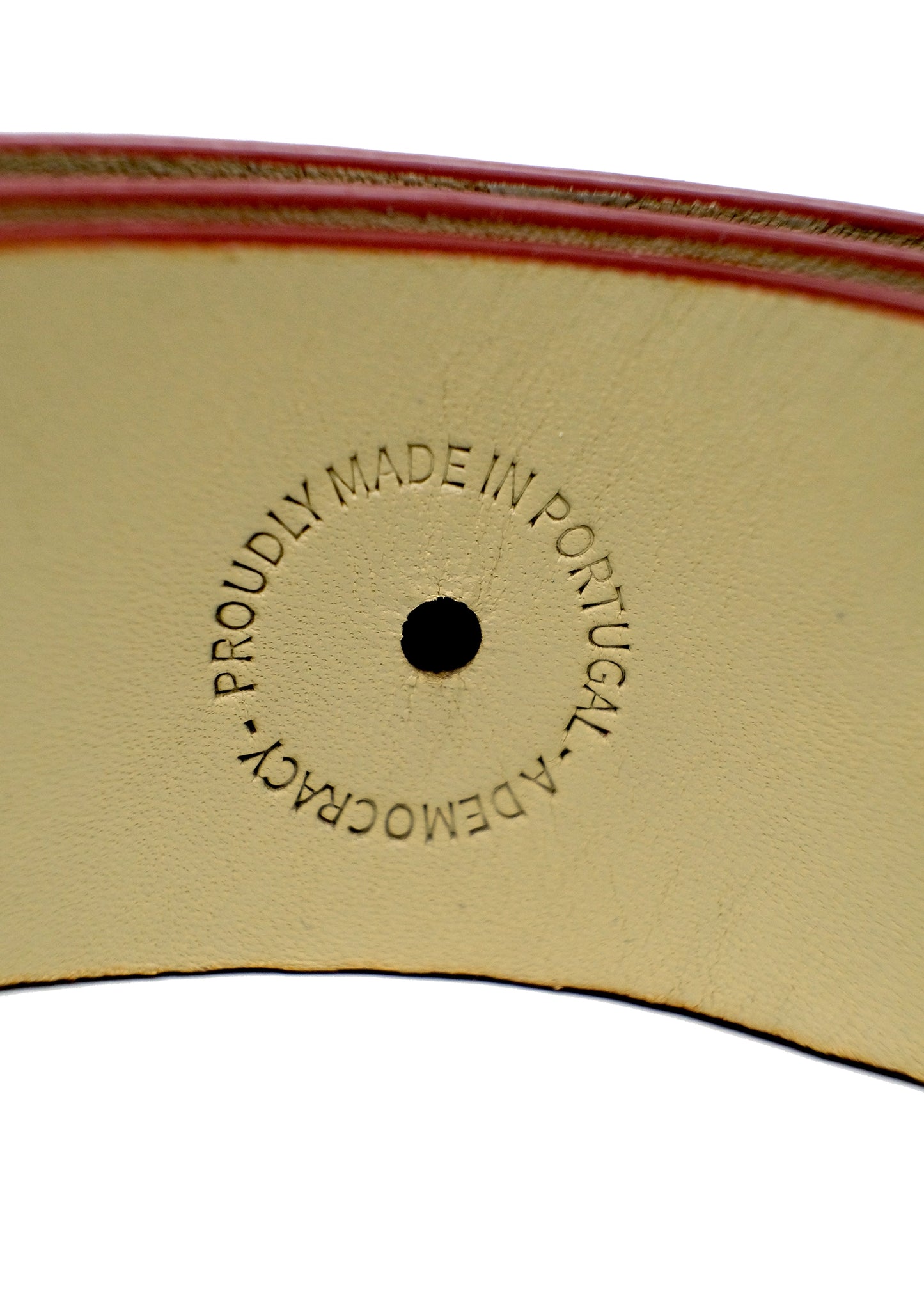 Close-up of a Blood Simple belt's interior showing the "PROUDLY MADE IN PORTUGAL - A DEMOCRACY" embossed stamp.