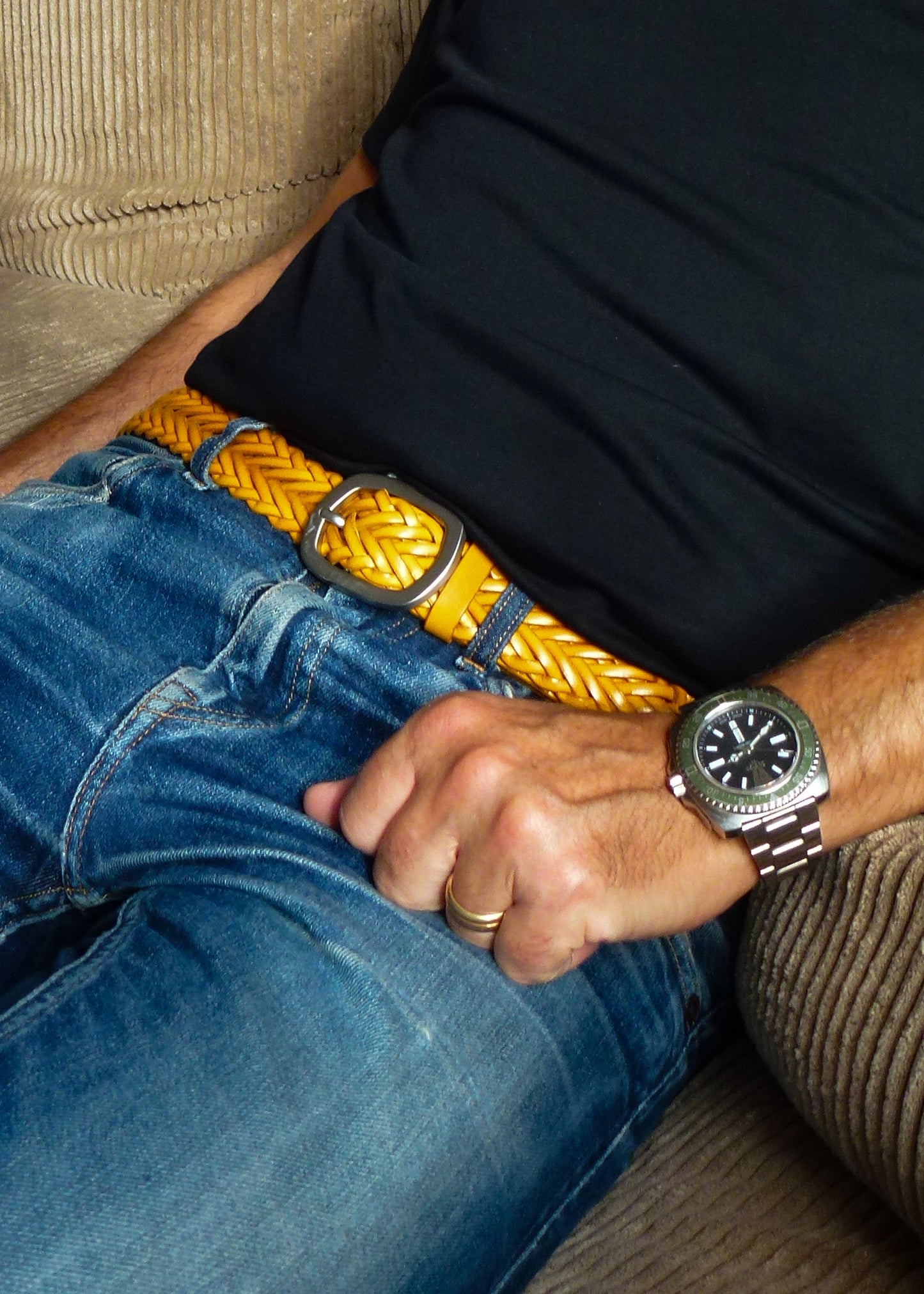 Submarine Yellow braided belt styled with blue jeans, a black t-shirt and a silver wristwatch.