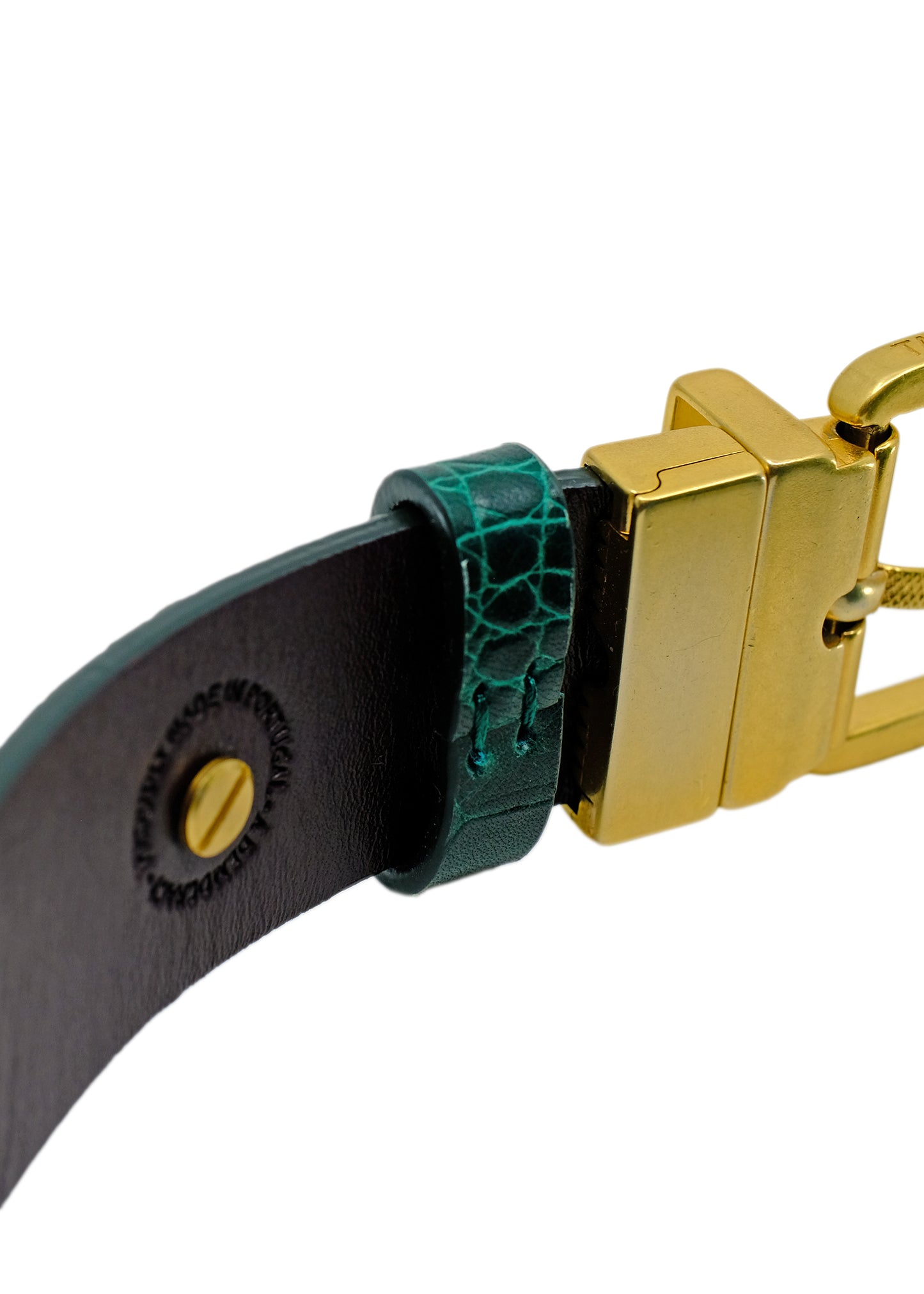 Close-up of the Two-Face belt's interior, showing the gold swivel buckle attachment and the "Proudly Made in Portugal" stamp on the Red Mist leather.