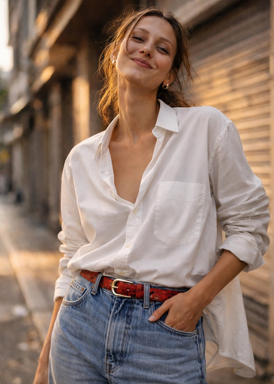 Blood red snakeskin belt with a silver buckle, styled on light blue denim with a white linen shirt.