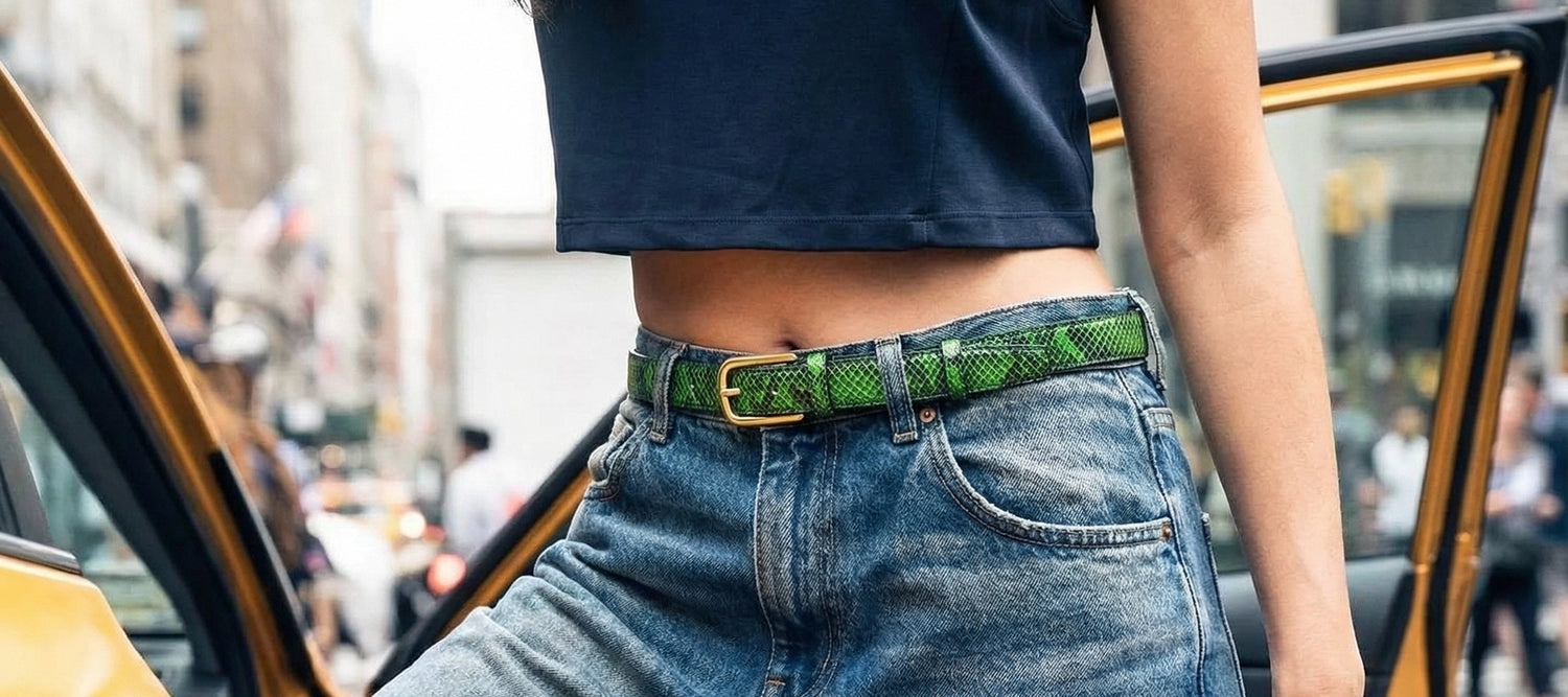 Atomic Green snakeskin belt with a gold buckle, worn on blue faded denim jeans and a dark crop top for a vibrant urban look.