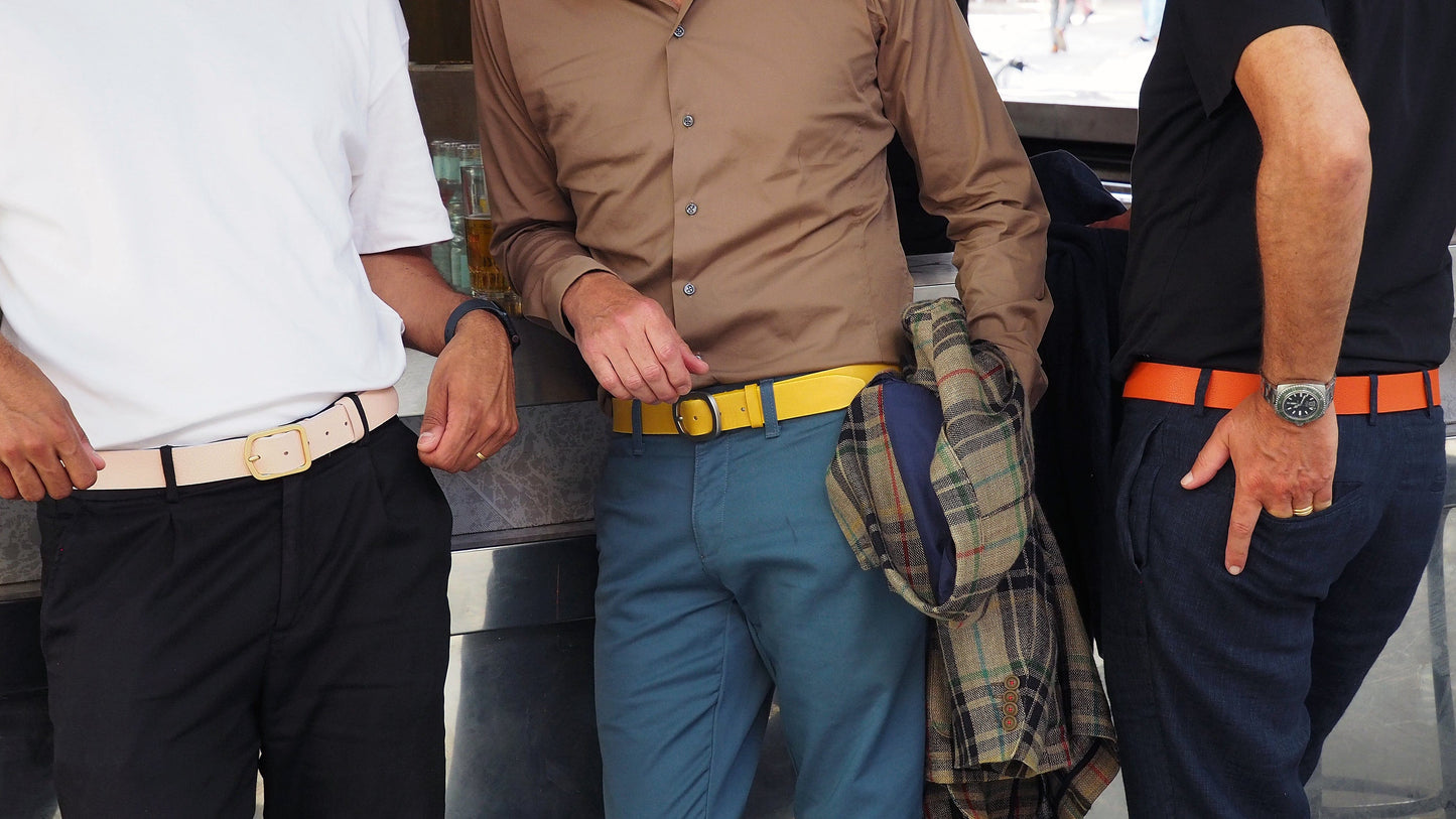 Picture of three men at a is bar wearing Classic leather belts in Barbie Pink, Tatooine sunset and submarine yellow.