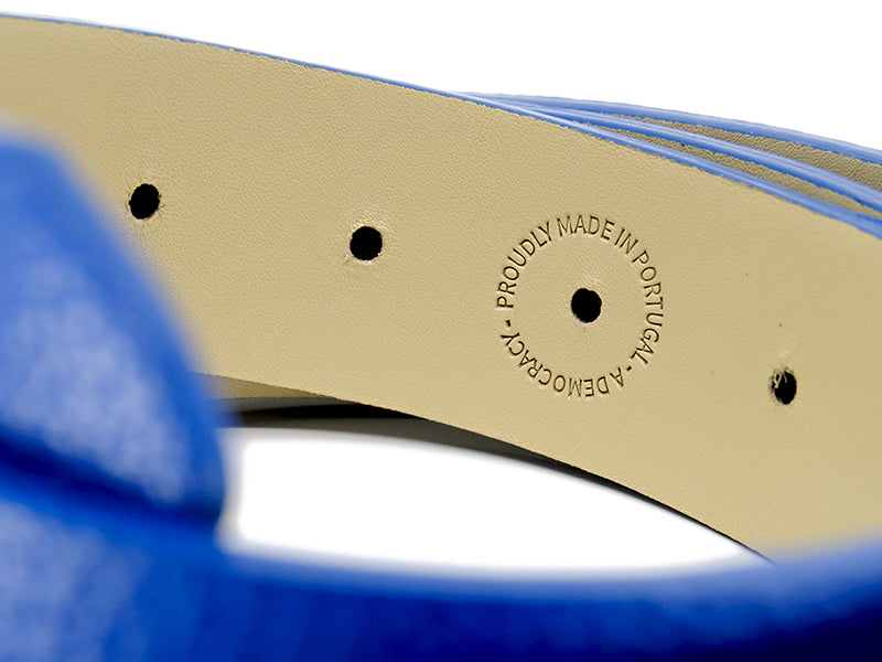 Extreme close-up of the inside details of a blue Grunge leather belt with text proudly made in Portugal, a democracy.