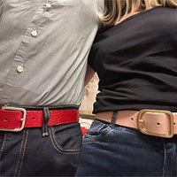 A shoot of a couple wearing grunge leather belt in pink and red.