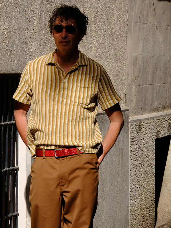 Lifestyle photo of man with croco embossed blood red leather belt with an antique silver buckle.